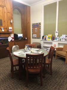 the Pine room features a table and four chairs, as well as three recliners and a fishtank